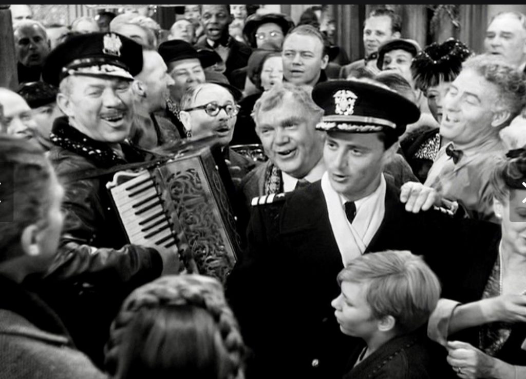 Frank Capra entertainig with accordion on movie set of You cant take it with you