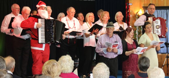 Santa (Lionel Reekie) and Kevin Friedrich performing Christmas Carols with Take Six Rivertown Singers