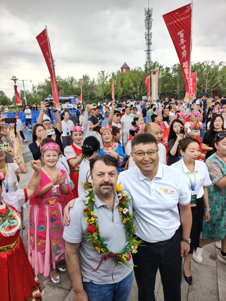 Mirco Patarini and Mayor of Tacheng with some of the audience in the background